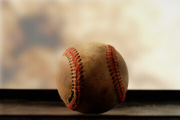Seams on baseball closeup with blurred background for sports nostalgia style.