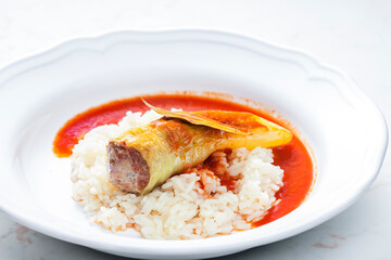 pepper stuffed with minced meat served with tomato sauce and rice