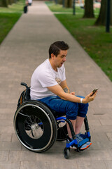 Inclusiveness A man with disabilities in a wheelchair looks into a smartphone and marvels at what...