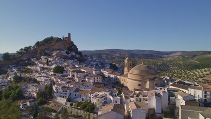 Montefrio. Panoramic aerial view of dome, white village and church on the cliff. One of the most...