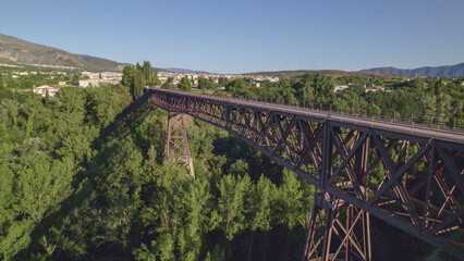 Obraz premium Old iron bridge over the grove. Aerial view of old railway bridge. Andalusia. Spain.