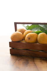 Fresh mangoes in wooden basket, mango fruit photography