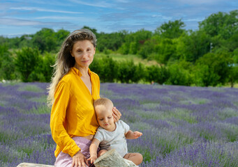Fototapeta premium Mother and her baby in the lavender field .