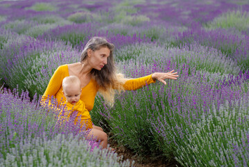 Mother and her baby in the lavender field .