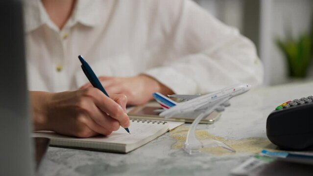 Travel, Middle-aged woman Happy Writes travel plans in a diary In a conference room, A happy traveler plans a vacation in another country With the aim of visiting other beautiful places, a wanderer