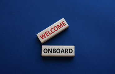 Welcome onboard symbol. Concept words Welcome onboard on wooden blocks. Beautiful deep blue background. Business and Welcome onboard concept. Copy space.