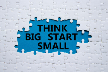 Think big start small symbol. Concept words Think big start small on white puzzle. Beautiful blue...