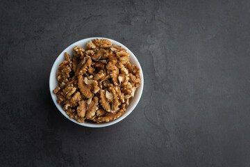 Top view of walnut with bowl and copy space for text