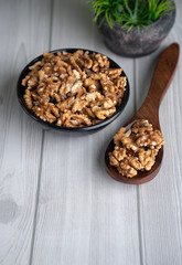 Bowl of walnuts with wooden spoon 