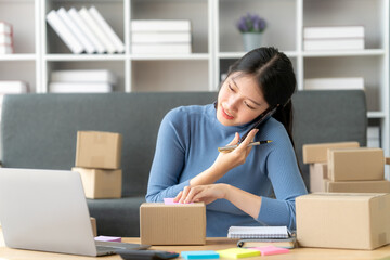 Portrait of Starting small businesses SME owners female entrepreneurs working on receipt box and check online orders to prepare to pack the boxes, sell to customers, SME business ideas online.