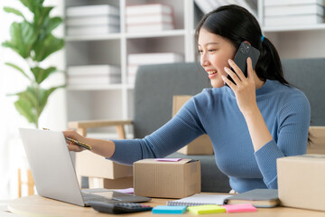 Portrait of Starting small businesses SME owners female entrepreneurs working on receipt box and check online orders to prepare to pack the boxes, sell to customers, SME business ideas online.