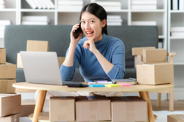 Portrait of Starting small businesses SME owners female entrepreneurs working on receipt box and check online orders to prepare to pack the boxes, sell to customers, SME business ideas online.