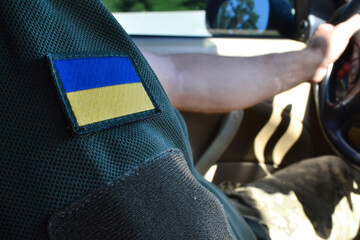 a military man has a Ukrainian flag on his T-shirt
