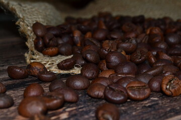 coffee beans scattered on a dark table