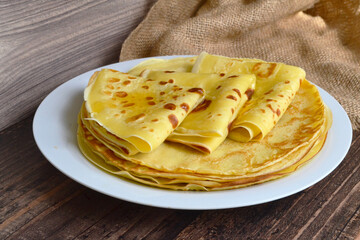 a plate with pancakes on a dark table