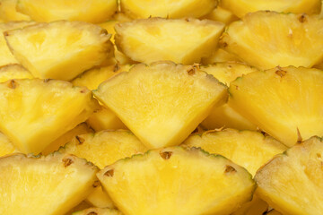 Pineapple juicy yellow slices as a background.
