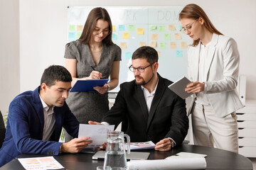 Group of people working on business plan in office
