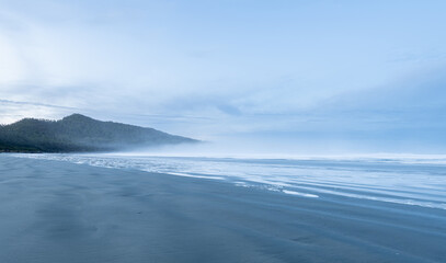 Misty sunrise over empty west coast beach