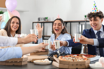 Group of business people drinking at birthday party in office