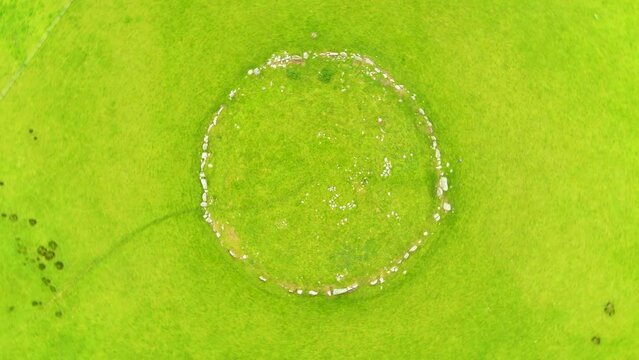 Aerial top-down view of female tourist exploring the famous Beltany stone circle