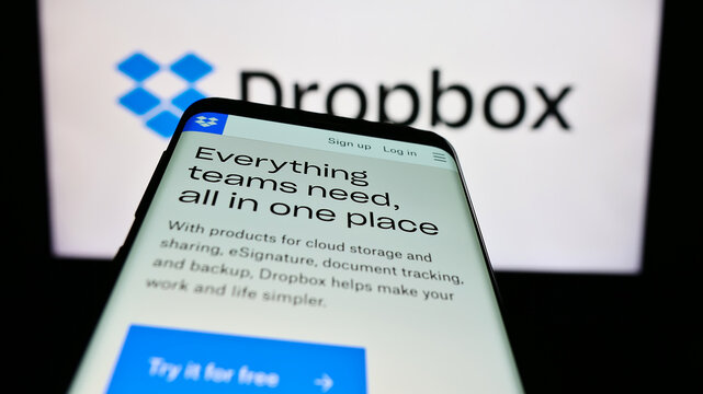 Stuttgart, Germany - 07-11-2023: Mobile phone with website of US file hosting company Dropbox Inc. on screen in front of business logo. Focus on top-left of phone display.