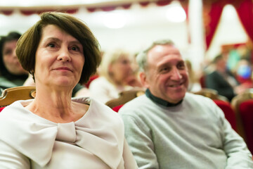 Mature man and woman in theater watching a performance