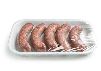 Raw pork sausages in plastic packaging on white background