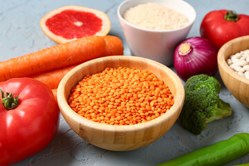 Different fresh vegetables and cereals on blue background
