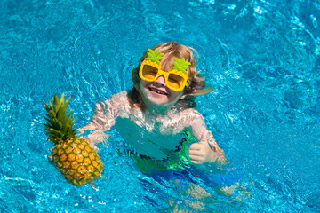 Child playing in the swimming pool. Summer kids activity.