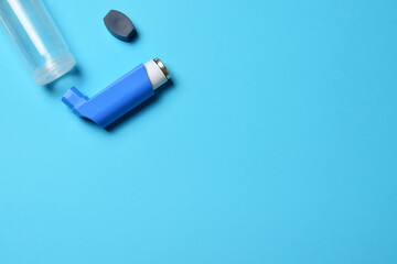 Overhead view, inhaler on blue background.