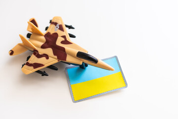 Plastic toy military jet plane on white background. 
