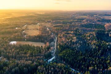 Aerial view of sunset over countryside fields ,forest and river.