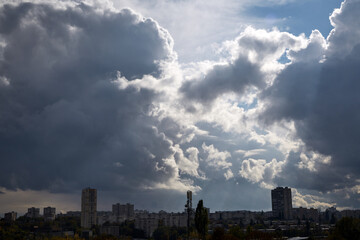 Clouds thicken over a major city before a storm. The storm is gathering over the city.