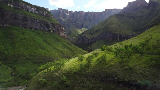 Drone shot of hikers in the landscapes surrounding the natural amphitheatre in the Drakensberg mountain range of South Africa.