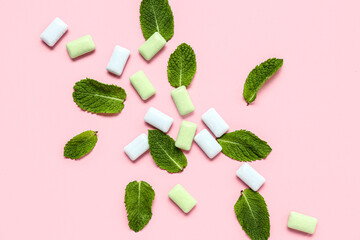 Fresh chewing gums with mint on pink background