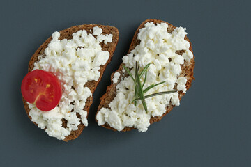 Tasty sandwiches with cottage cheese on black background
