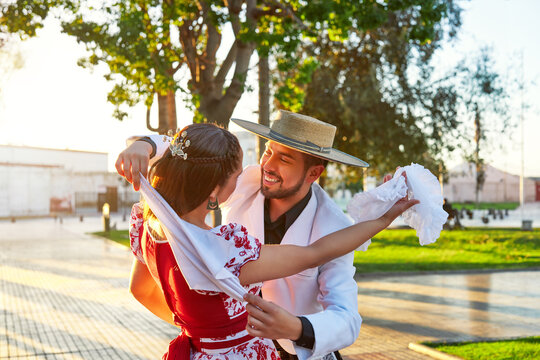 portrait latin american man hugs a woman dressed as huaso dancing cueca in the square