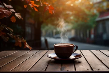 Fototapeten a cup of coffee on wooden cafe table street view with fall autumn trees © Sam