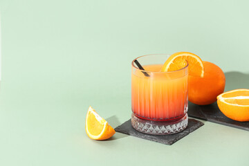 Glass of tasty mai tai cocktail on green background