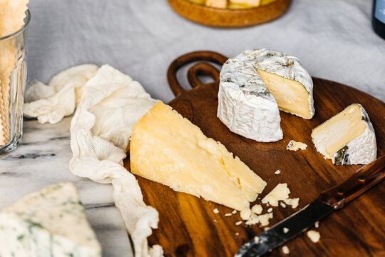 Styled cheese board scene on wooden cutting board