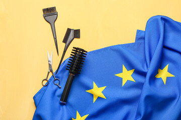 Flag of European Union and hairdresser tools on yellow background