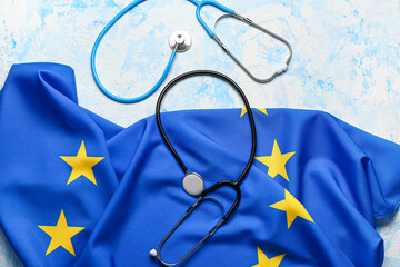 Flag of European Union with stethoscopes on light blue background