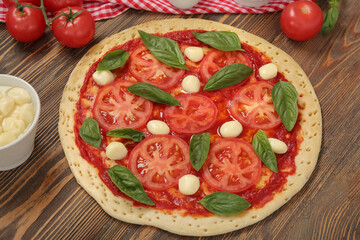 Tasty pizza on wooden background