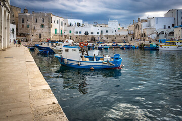 old harbour in monopoli, puglia, italy, bari, porto antico, fishing boat, dramatic sky, 