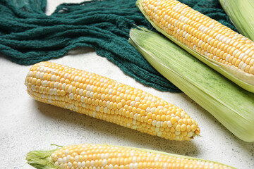 Fresh corn cobs on light background