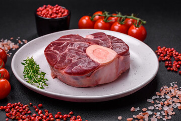 Fresh raw beef steak with bone or ossobuco with salt, spices and herbs