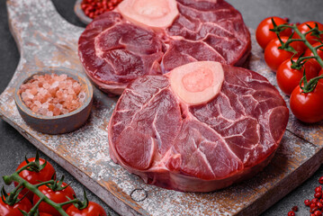 Fresh raw beef steak with bone or ossobuco with salt, spices and herbs