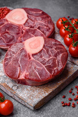 Fresh raw beef steak with bone or ossobuco with salt, spices and herbs