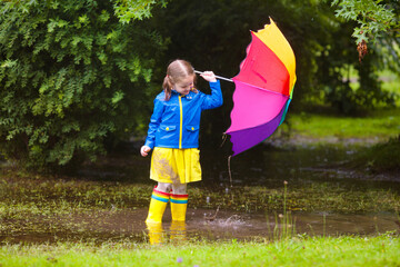 Little girl with umbrella in the rain