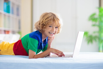 Online remote learning. School kids with computer.